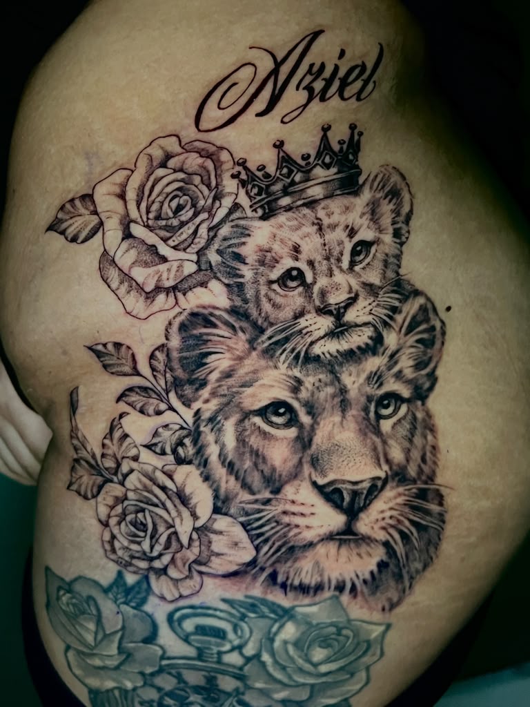 Black and grey lion and cub tattoo with crown, roses, and name script by Alison at Inked City Tattoos in Trenton, NJ